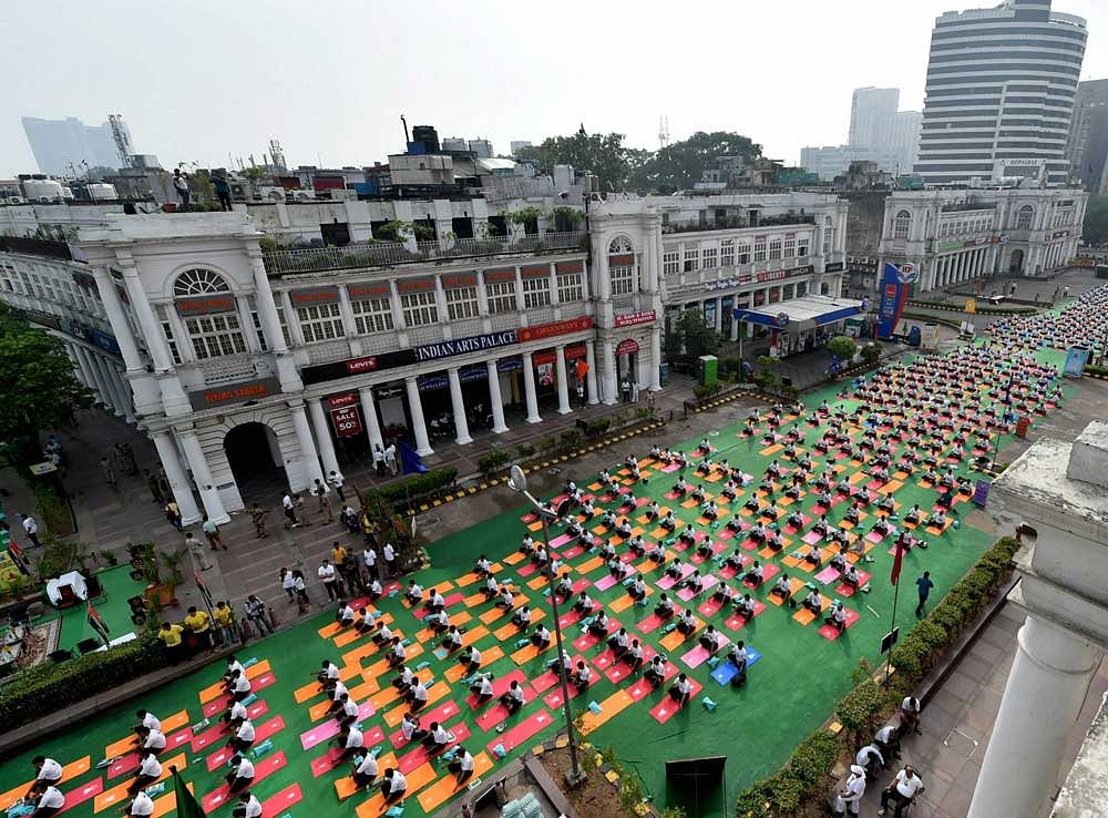 Yoga enthusiasts perform yoga at Connaught Place area to mark the 3rd International Yoga Day 2017 in New Delhi on Wednesday. PTI Photo