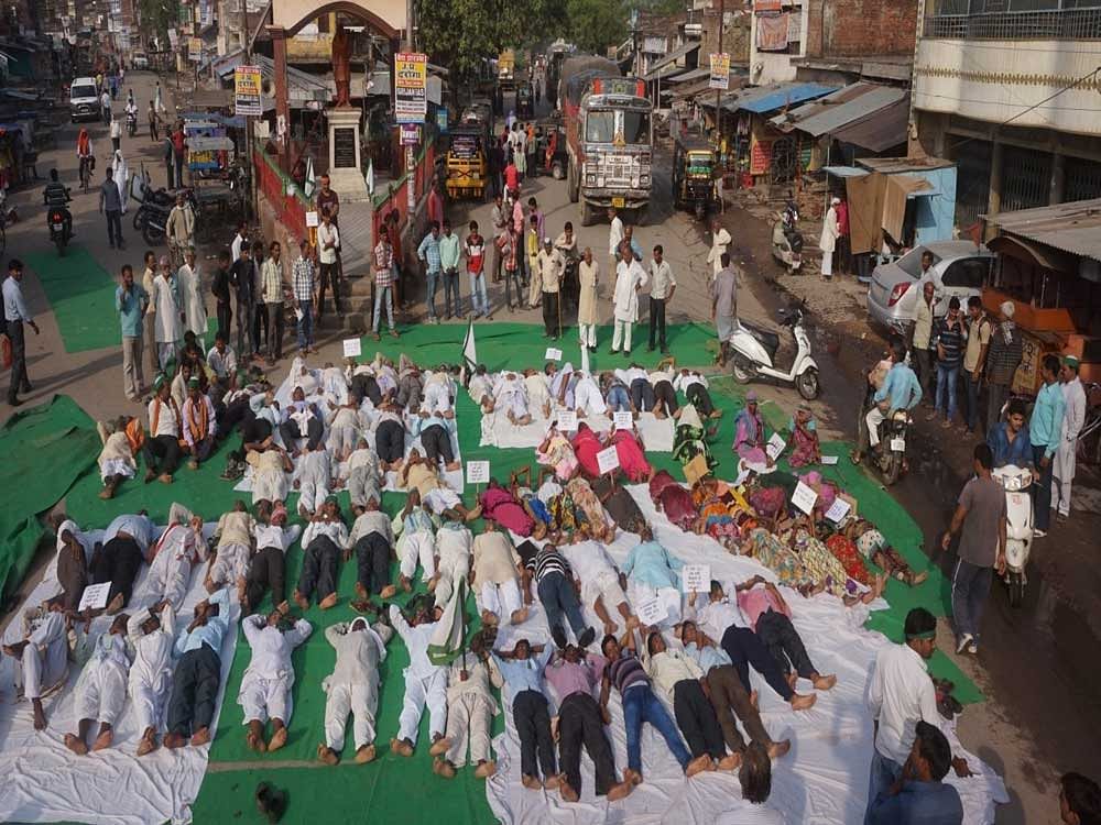 Farmers today performed 'shavasana' or the corpse pose to register their protest . Twitter