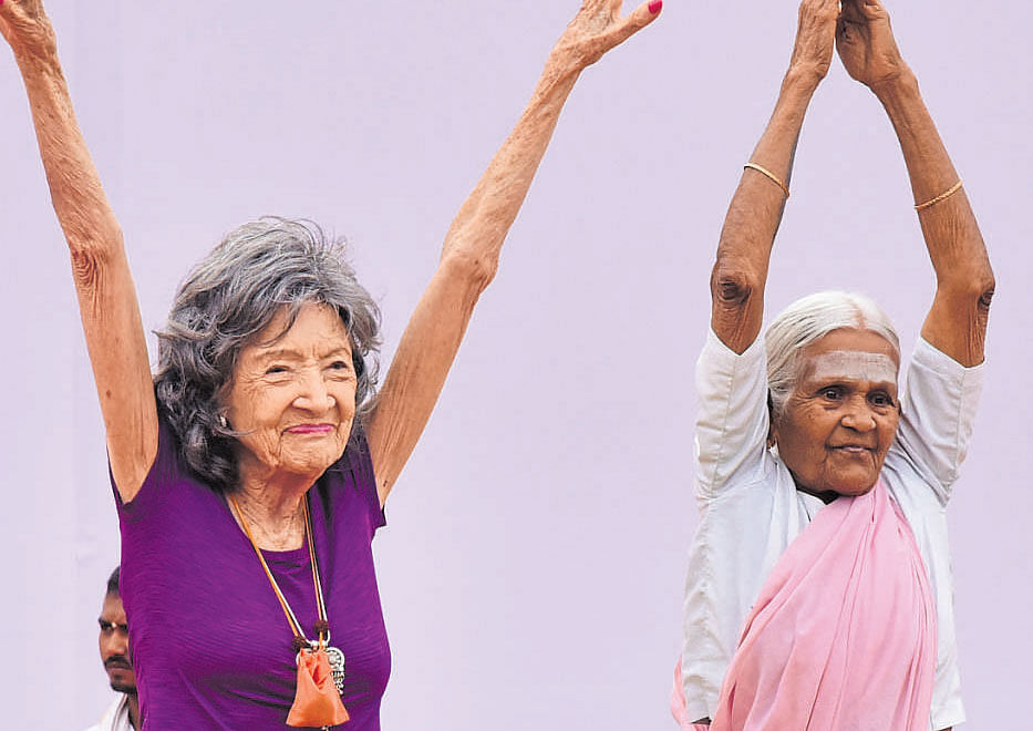 Yoga teachers Tao Porchon Lynch, 98, and Amma Nannamal, 97, perform yoga at International Yoga Day progarmme at Kanteerava Stadium on Wednesday.