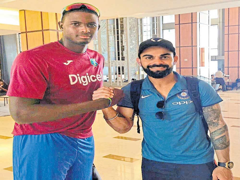 Indian skipper Virat Kohli (right) poses with West Indies' skipper Jason Holder  after arriving in the Caribbean for the limited-overs series. Twitter