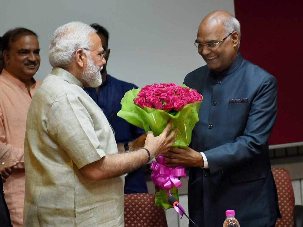 NDA's presidential nominee Ram Nath Kovind being greeted by Prime Minister Narendra Modi during an NDA meeting at Parliament in New Delhi on Friday. PTI Photo