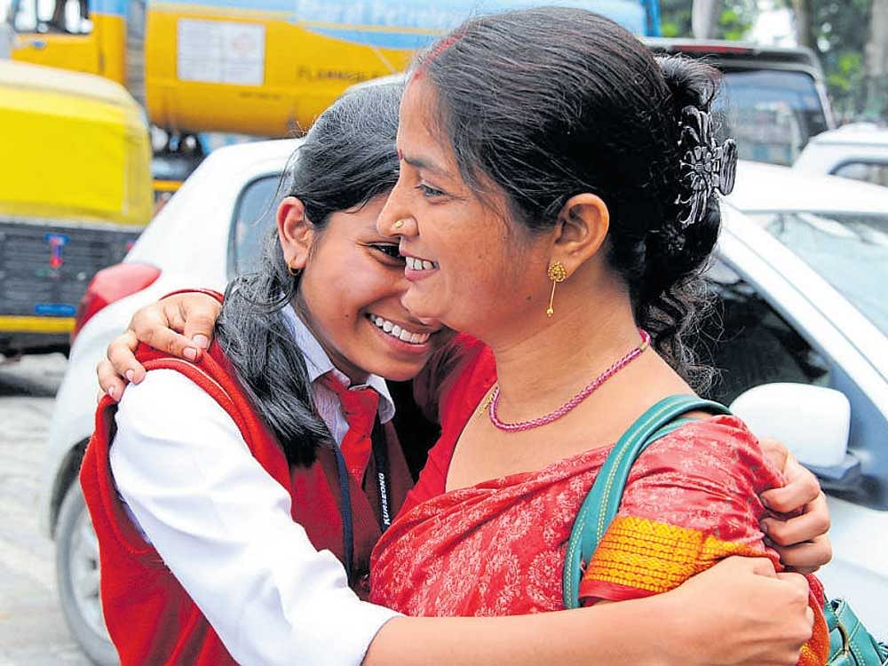 A school student with her mother on her arrival at Siliguri from Darjeeling as the Gorkha Janamukti Morcha on Friday gave a 12-hour window to evacuate schools in the hills. AFP