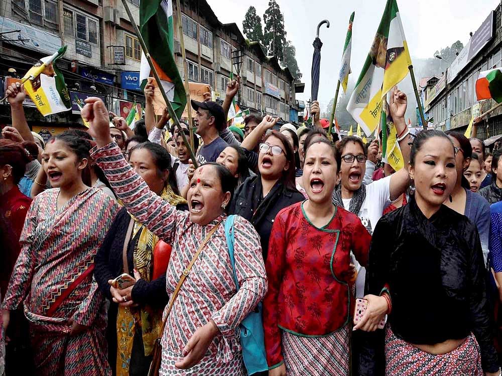 People raise slogans as they participate in a mass rally to demand for separate state of 'Gorkhaland' in Darjeeling on Saturday. PTI Photo