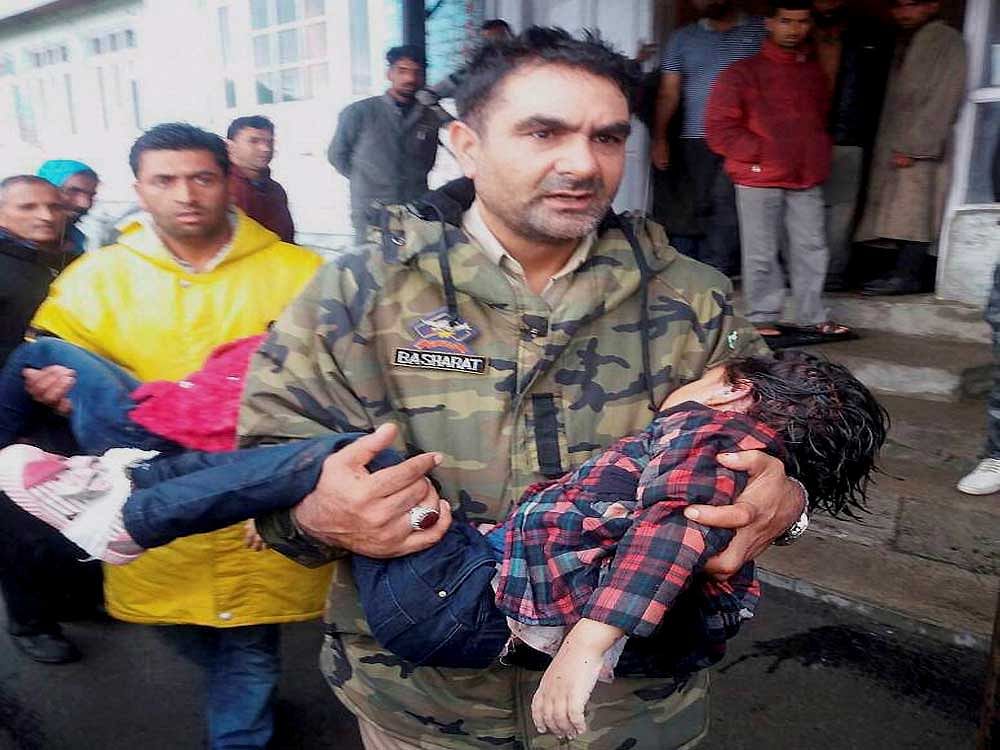 A policeman carries an injured child to a hospital after a cable-car snapped at the famous ski-resort of Gulmarg in north Kashmir's Baramulla district on Sunday. Five tourists, four of them from a family from Delhi, were killed in the mishap. PTI Photo
