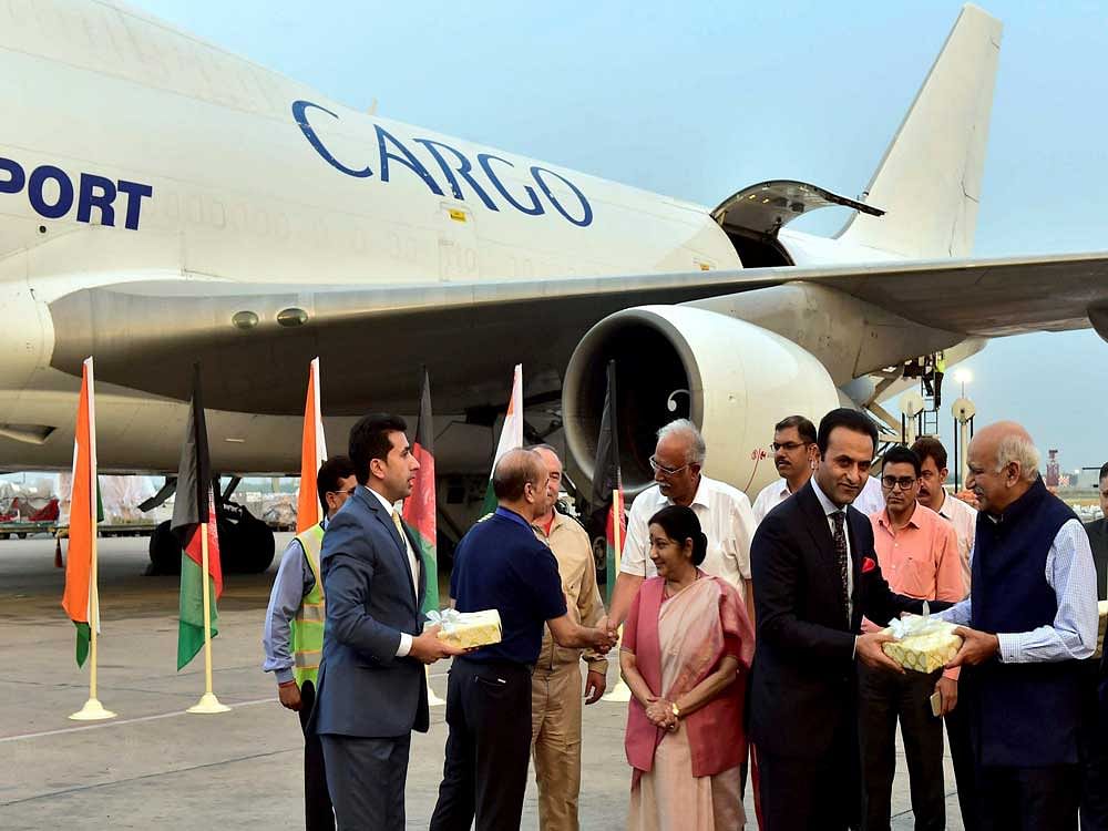 External Affairs Minister Sushma Swaraj, Civil Aviation Minister Ashok Gajapathi Raju and Minister of State M J Akbar during the reception of the first flight of the India-Afghanistan air corridor project, at IGI Airport in New Delhi. The flight carried approximately 100 Mts of cargo which includes pharmaceutical products, water purifiers, clothings and footwears and many other items. PTI Photo