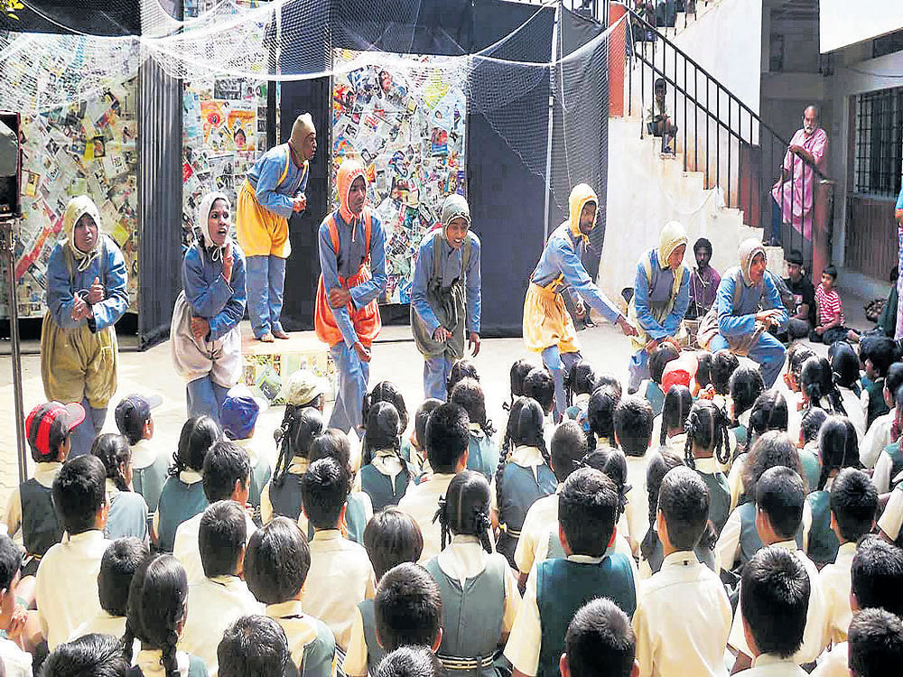 Kinnara Mela artistes performing a play for students