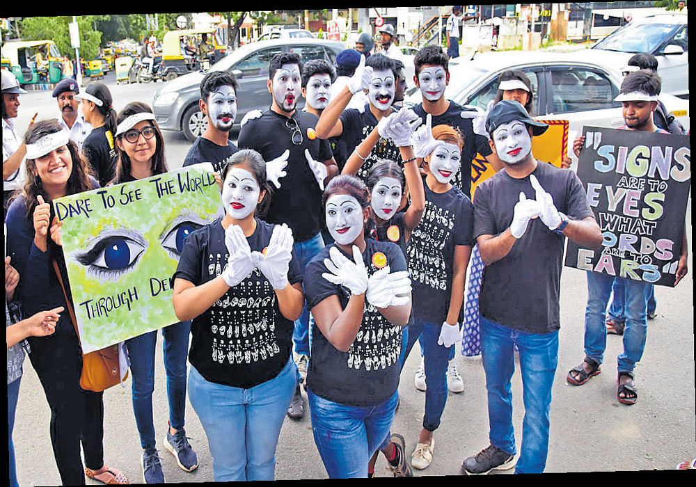 committed: Young people are increasingly coming out on the streets to create awareness on social issues.  (Above) College students miming about the problems of the differently-abled recently. DH Photo by B H Shivakumar