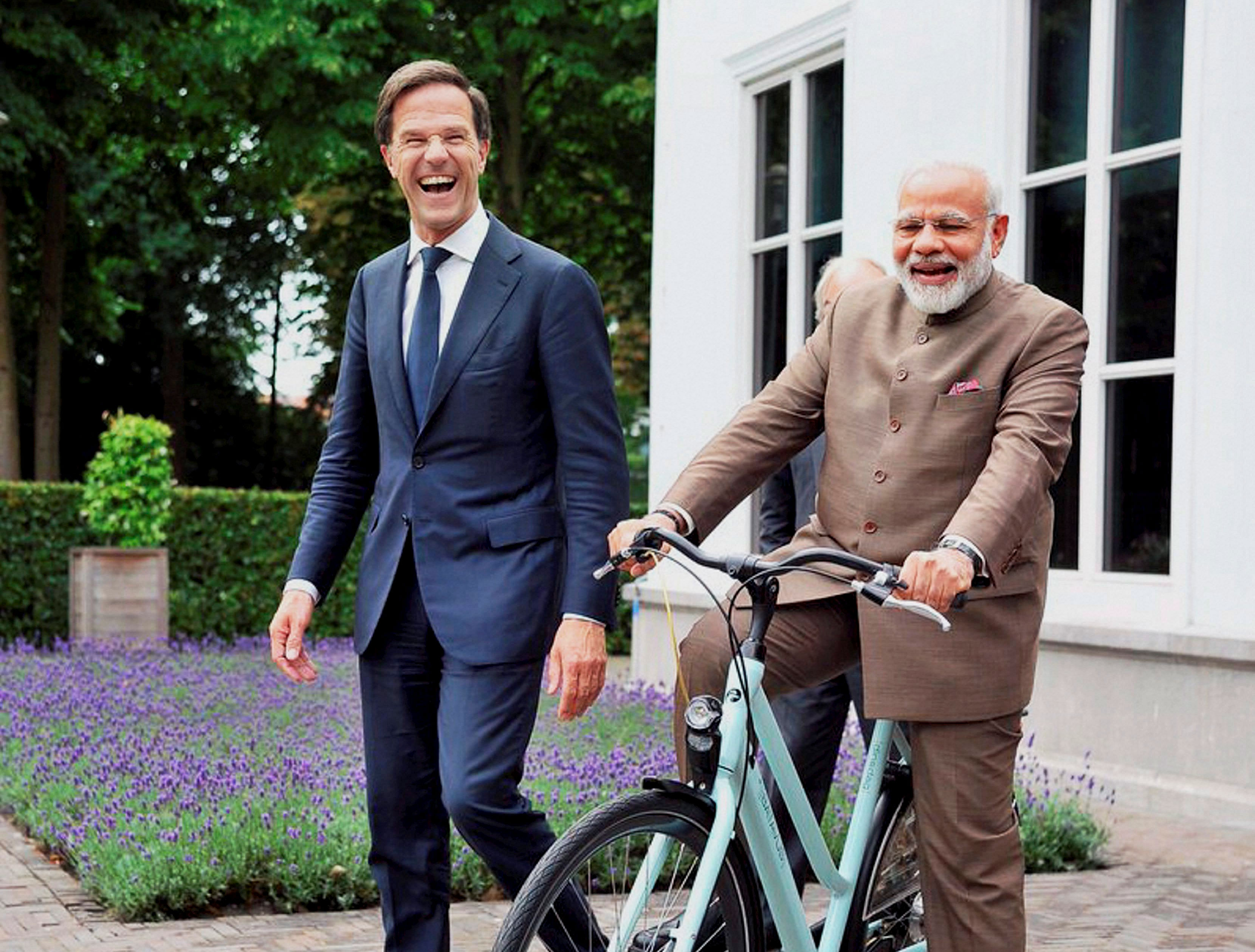 A picture shared by Prime Minister Modi on his twitter account shows him sitting and smiling on the Dutch-made bicycle which was gifted to him by Rutte yesterday. PTI photo