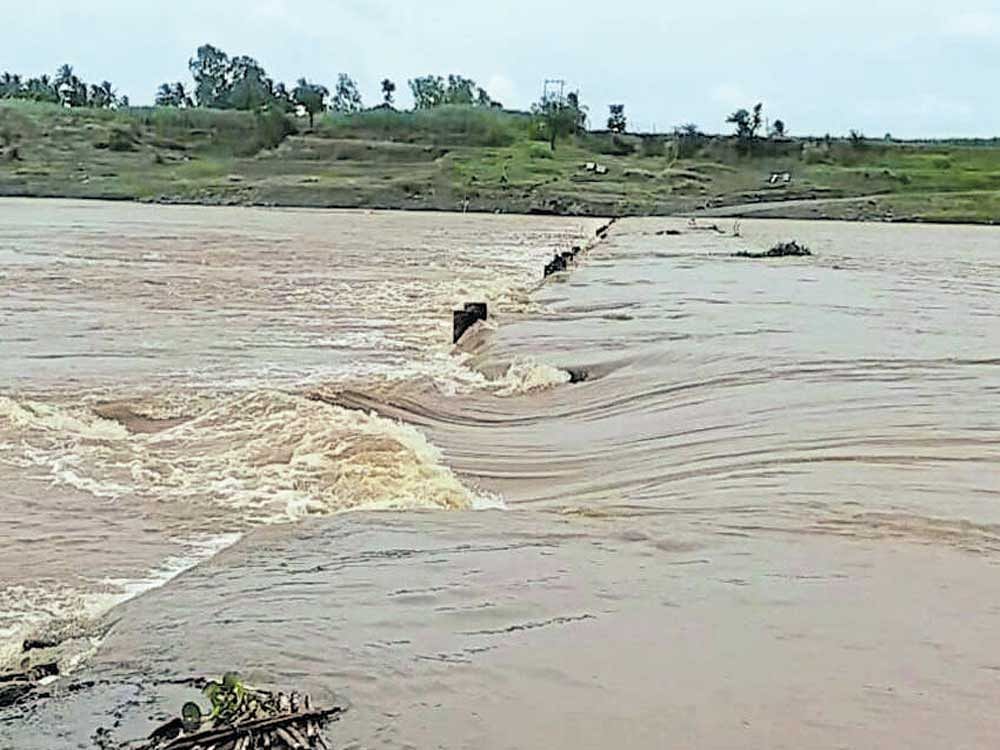 The low-lying bridge between Bavan and Saundatti across River Krishna of Belagavi district was submerged on Wednesday. The inflow into the river has increased owing  to heavy rain in catchment areas in Maharashtra.  DH Photo/Sudhakar Talwar