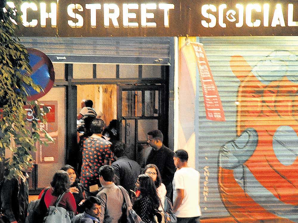Customers enter a pub on Church Street on Friday night. dh photo