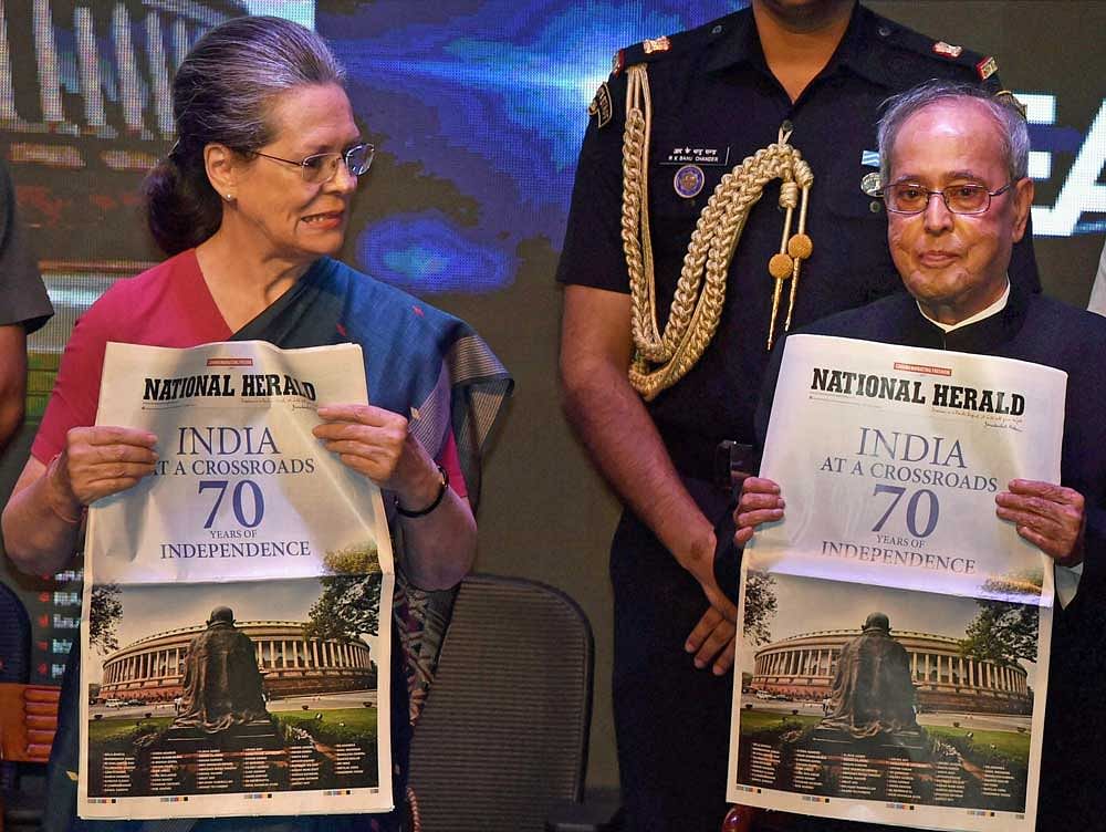 President Pranab Mukherjee with Congress President Sonia Gandhi release commemorative publication of National Herald at a function in New Delhi on Saturday. PTI Photo