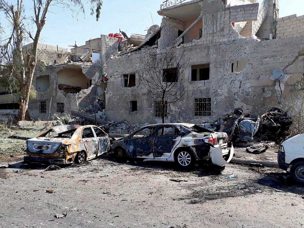 Damaged cars are seen at one of the blast sites in Damascus in this handout picture posted on SANA on July 2, 2017, Syria. SANA/Handout via REUTERS