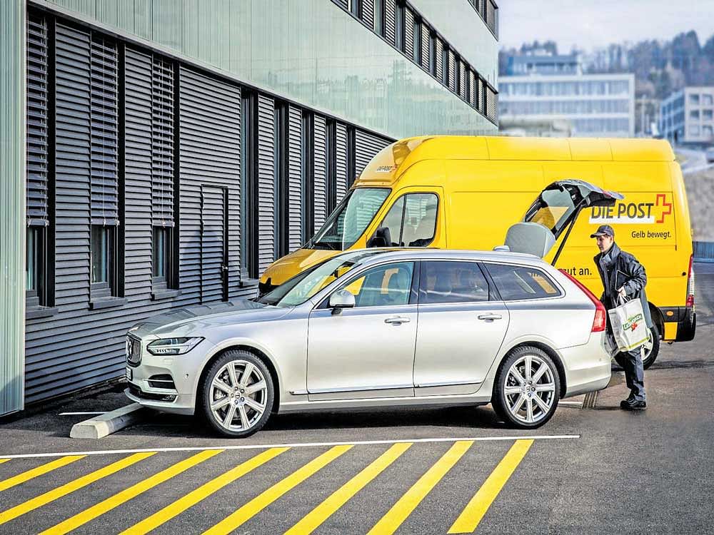 An image from Volvo illustrates the working of their in-car delivery service. (inset) A computer chip used by D-Wave Systems. Carmakers are jumping into development of new digital technologies with the hope of beating Apple and Google at their game. NYT