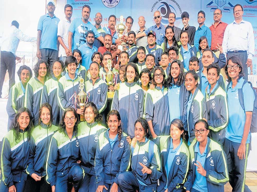 Unstoppable: Karnataka contingent pose with their overall championship trophy of the 44th Junior National Aquatics in Pune on Thursday.
