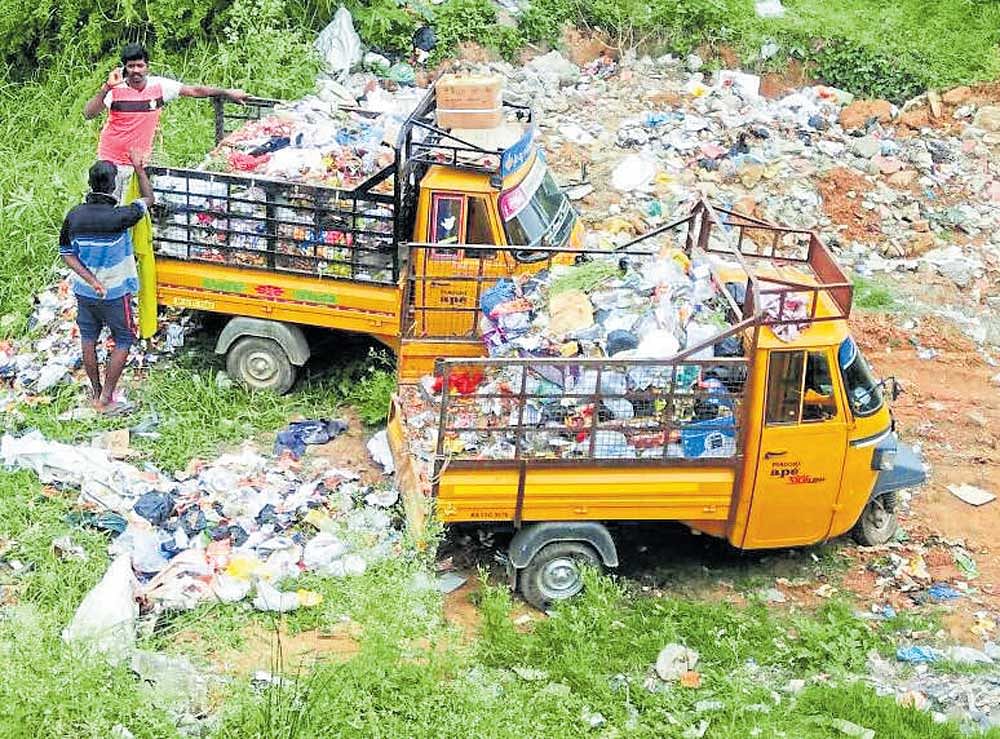 Waste being dumped at the Dodda Amanikere in Hoskote. Photo by special arrangement