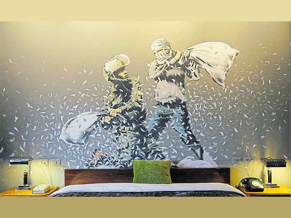 Painted Room: In The Walled Off Hotel,a mural brought to life by Banksy in which an Israeli policeman and a Palestinian are engaged in a pillow fight.