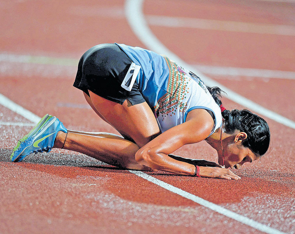 EMOTIONAL: India's Sudha Singh kisses the track after winning the women's 3000M steeplechase at the Kalinga stadium. PTI