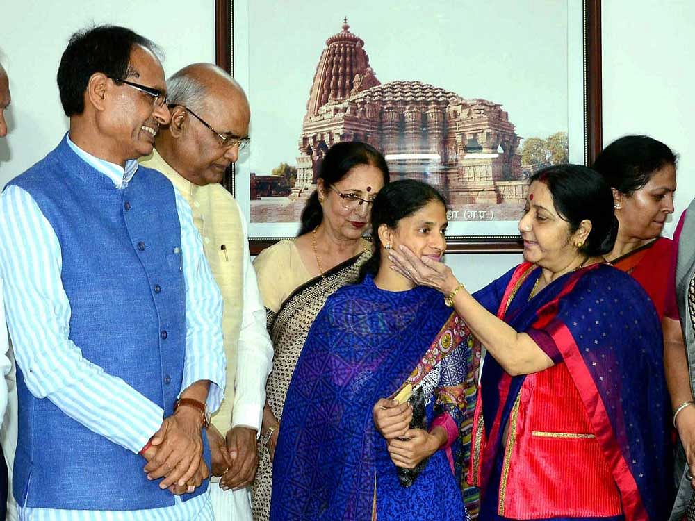 Union Minister for External Affairs Sushma Swaraj along with NDA's Presidential candidiate Ram Nath Kovind and Chief Minister Shivraj Singh Chouhan during a meeting with deaf mute girl Geeta, who brought to India from Pakistan, at his residence in Bhopal on Saturday. PTI Photo