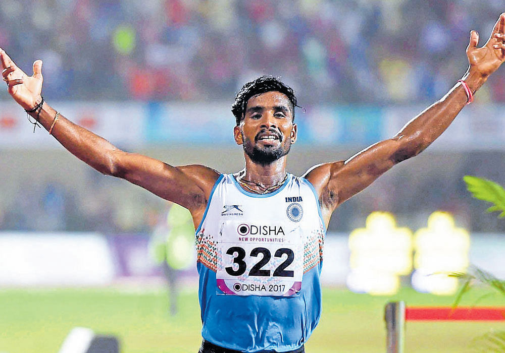 Brilliant show: India's G Lakshmanan celebrates after clinching the men's 10000 metres gold on the final day of the Asian Athletics in Bhubaneswar on Sunday. AFP