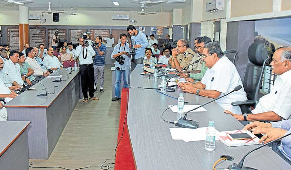 Dakshina Kannada district in-charge minister B Ramanath Rai addresses the peace meeting organised at deputy commissioner's office in Mangaluru on Thursday. MLA&#8200;Abhayachandra Jain (right)&#8200;is seen. dh photo