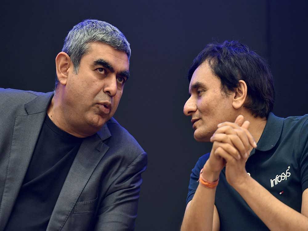 Infosys Technologies CEO Vishal Sikka (L) with CFO M D Ranganath during the announcement of the first quarter results of the company at its headquarters in Bengaluru on Friday. PTI Photo