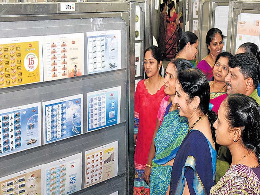 Visitors look at stamps and postal covers at Karphilex 2017, a state-level philatelic exhibition organised by the Karnataka Philatelic Society in Bengaluru on Friday. DH PHOTO