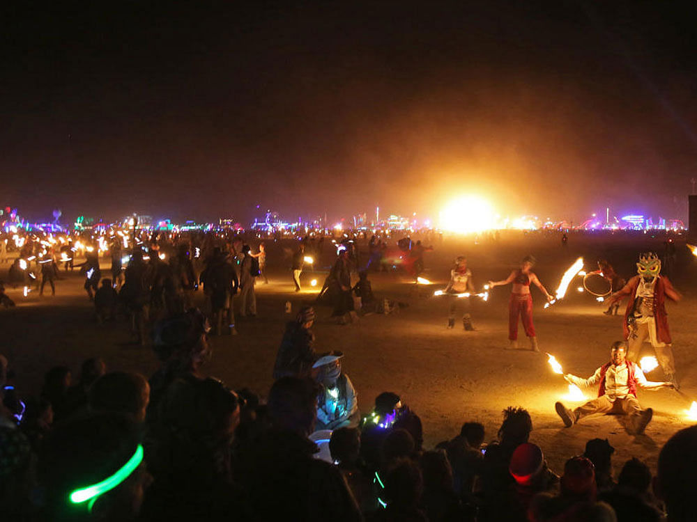 Fire play Revellers at the Burning Man  festival, an annual gathering in Black Rock  Desert, Nevada; (below) Lake Tahoe.