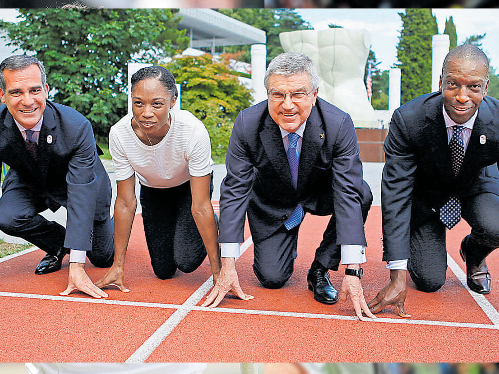 Get set... Mayor of Los Angeles Eric Garcetti, American sprinter Allyson Felix, International Olympic Committee President Thomas Bach and former American sprinter Michael Johnson (from left) at the Olympic Museum in Lausanne. Reuters