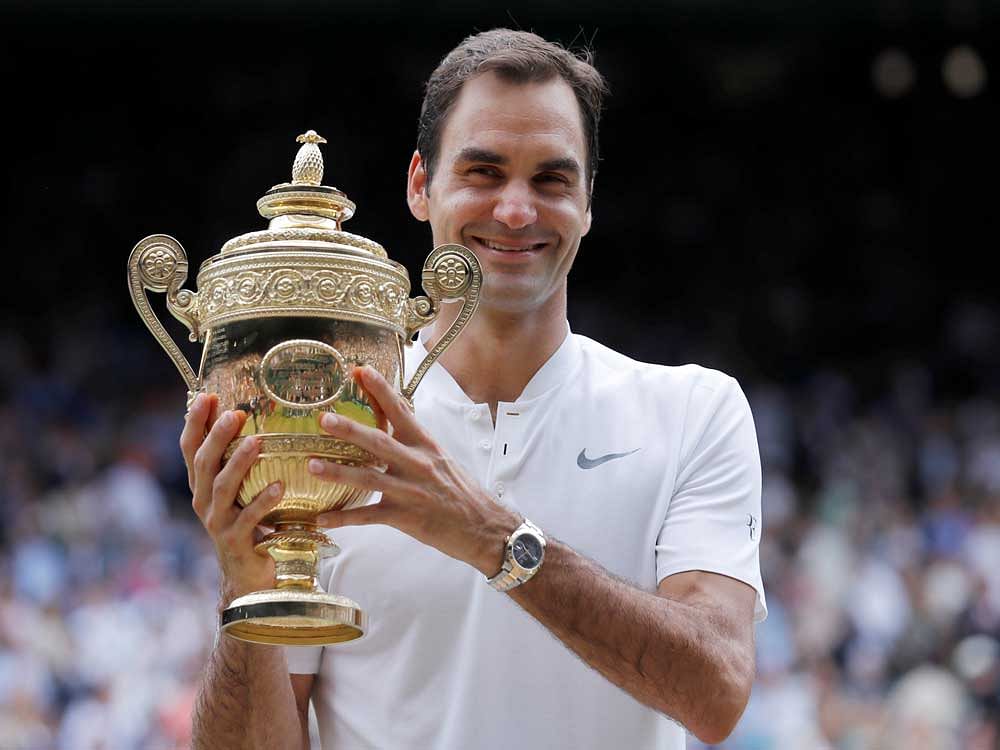 Roger Federer poses with the trophy as he celebrates winning the final against Marin Cilic. REUTERS photo