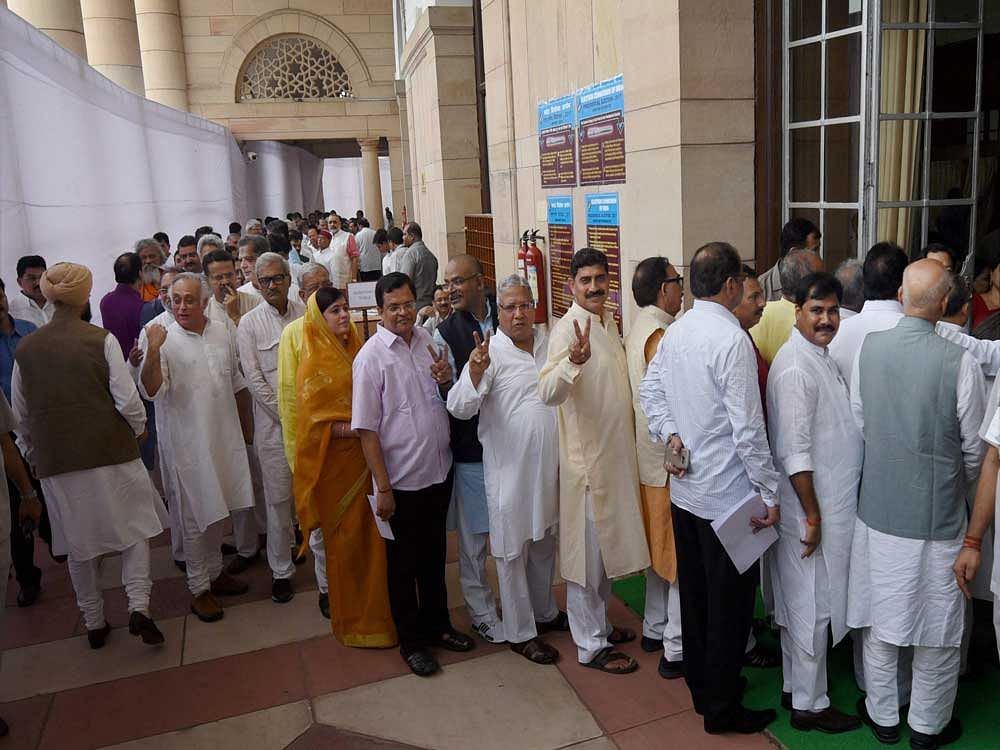 Members wait to cast their votes for the Election of the President at Parliament in New Delhi on Monday. PTI Photo