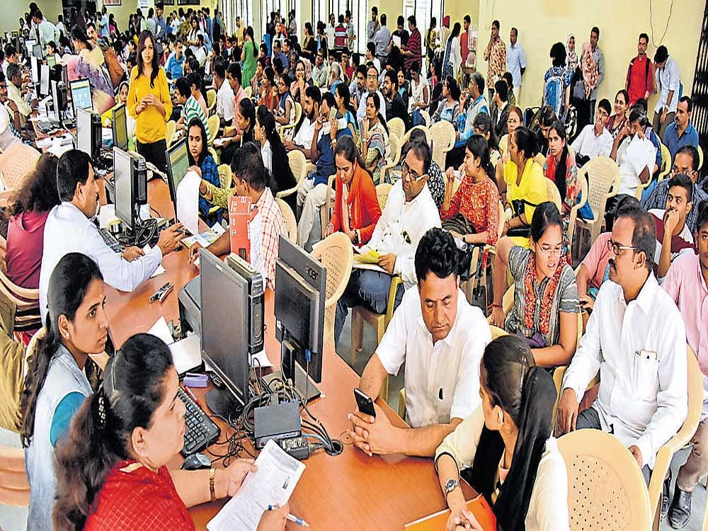 Students, along with their parents, appear for document verification for medical counselling at Karnataka Examinations Authority at Malleswaram on Tuesday. DH PHOTO