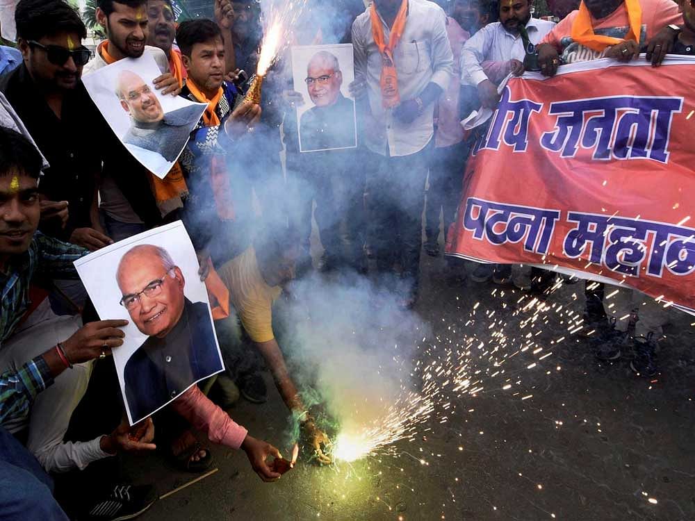BJP workers celebrate the early lead of NDA presidential nominee Ram Nath Kovind in Patna on Thursday. PTI photo