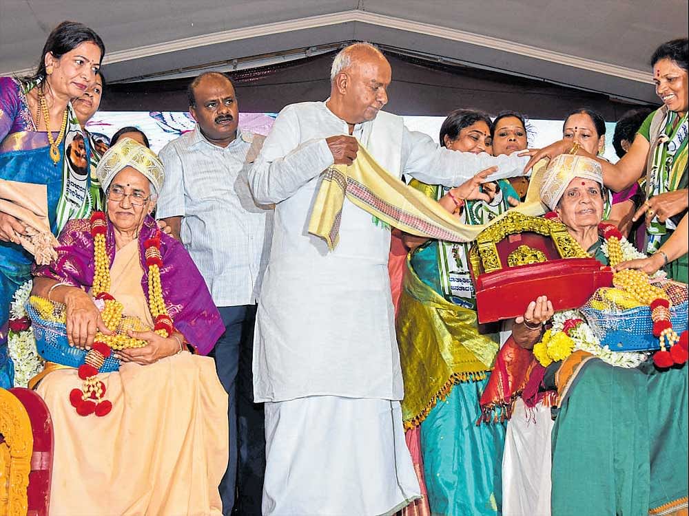 JD(S)&#8200;president H&#8200;D&#8200;Deve Gowda felicitates former ministers B&#8200;T&#8200;Lalitha Naik (left) and Leeladevi R Prasad at party's women's convention in Bengaluru on Thursday. dh Photo