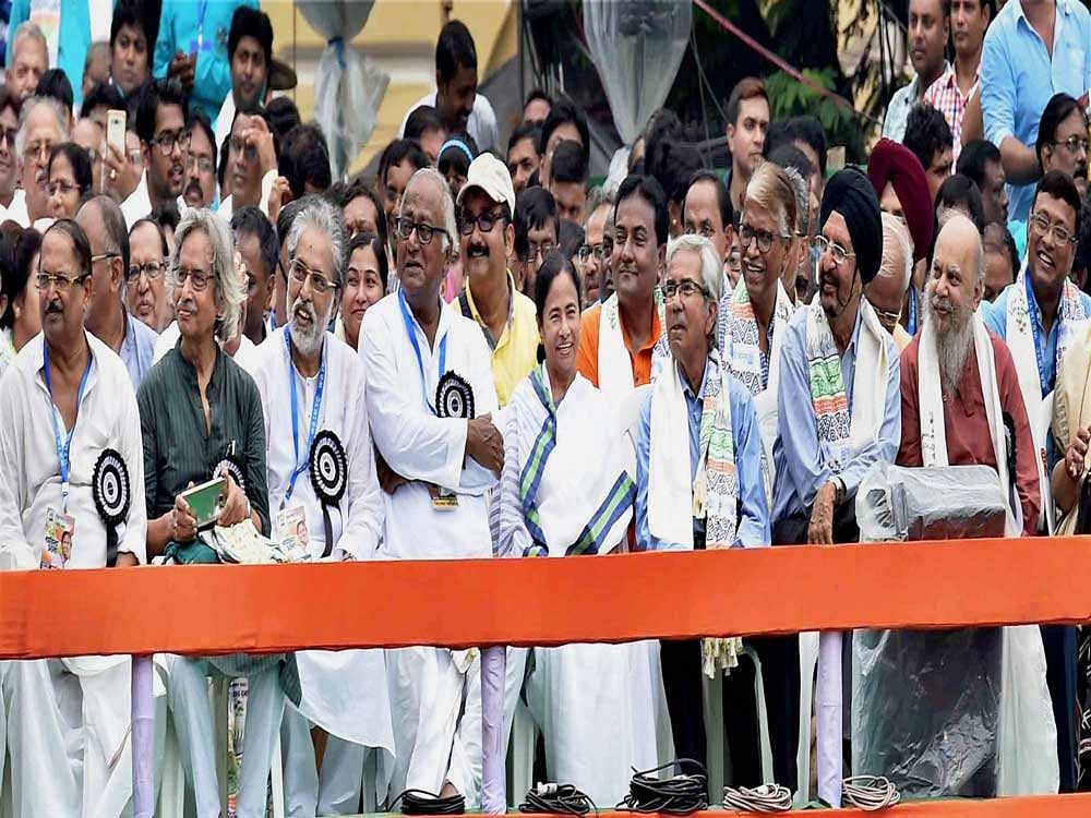TMC Party supremo and West Bengal Chief Minister Mamata Banerjee share the dias with party leaders and other eminent personalities during a rally to observe Martyr's day in Kolkata on Friday. PTI Photo