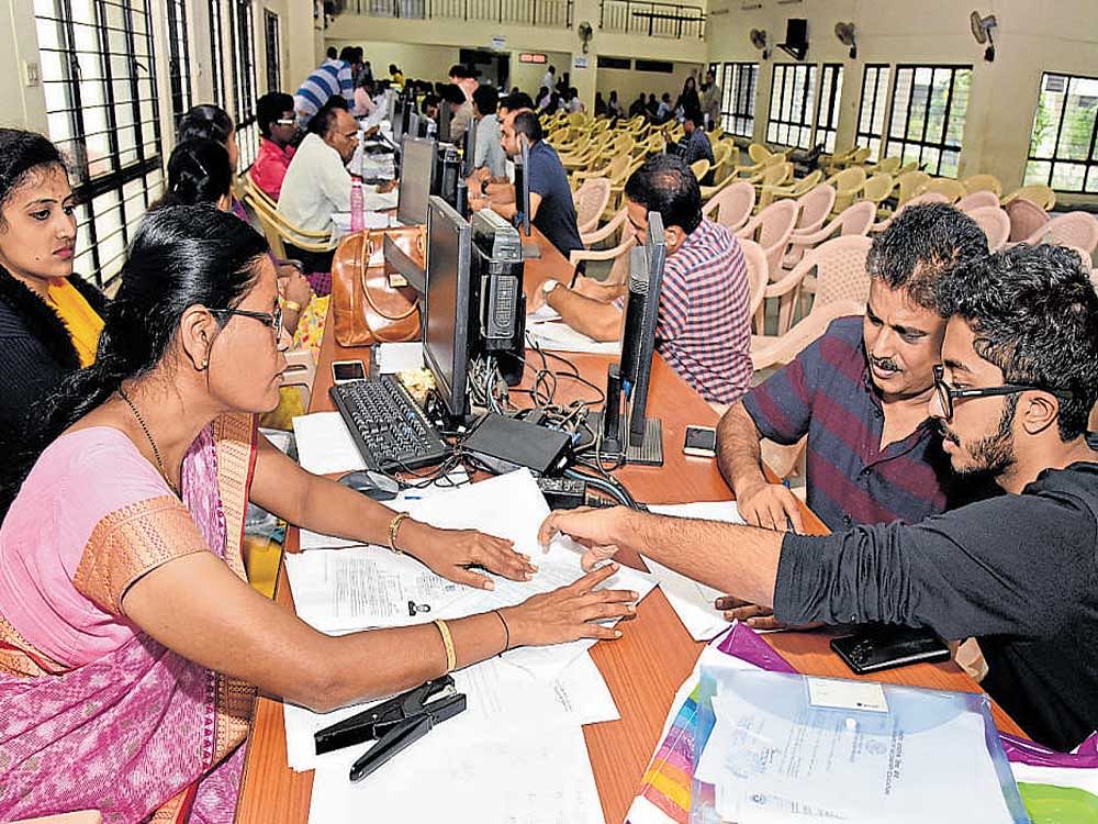 KEA officials verify documents belonging to candidates at the KEA centre at Malleswaram on Friday.