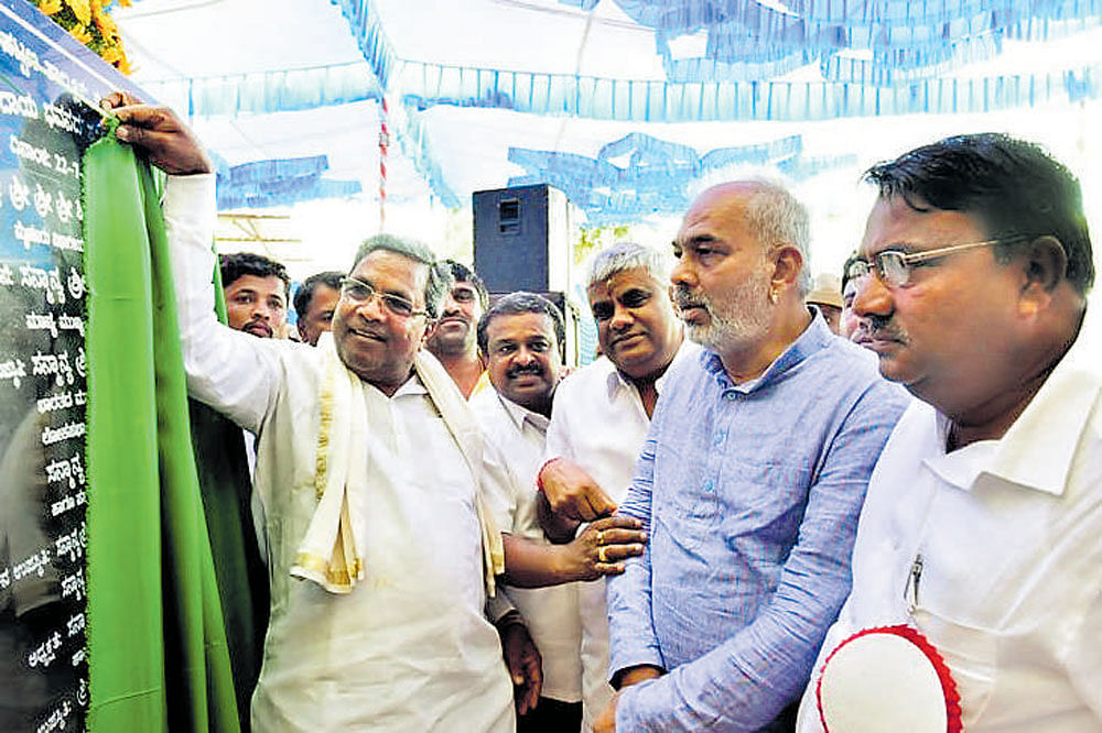 Chief Minister Siddaramaiah unveils a plaque to mark the foundation stone laying for Kanaka Bhavan in Channarayapatna, Hassan district, on Saturday.