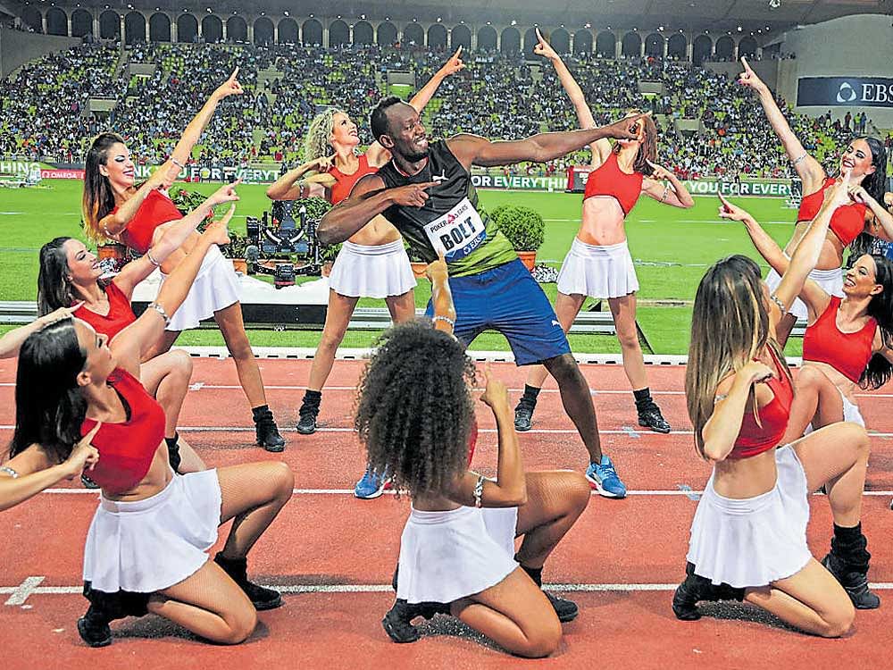 fun after work! Jamaican sprinter Usain Bolt (centre) celebrates with cheerleaders after clinching the 100M gold at the Monaco Diamond League meeting on Friday. REUTERS