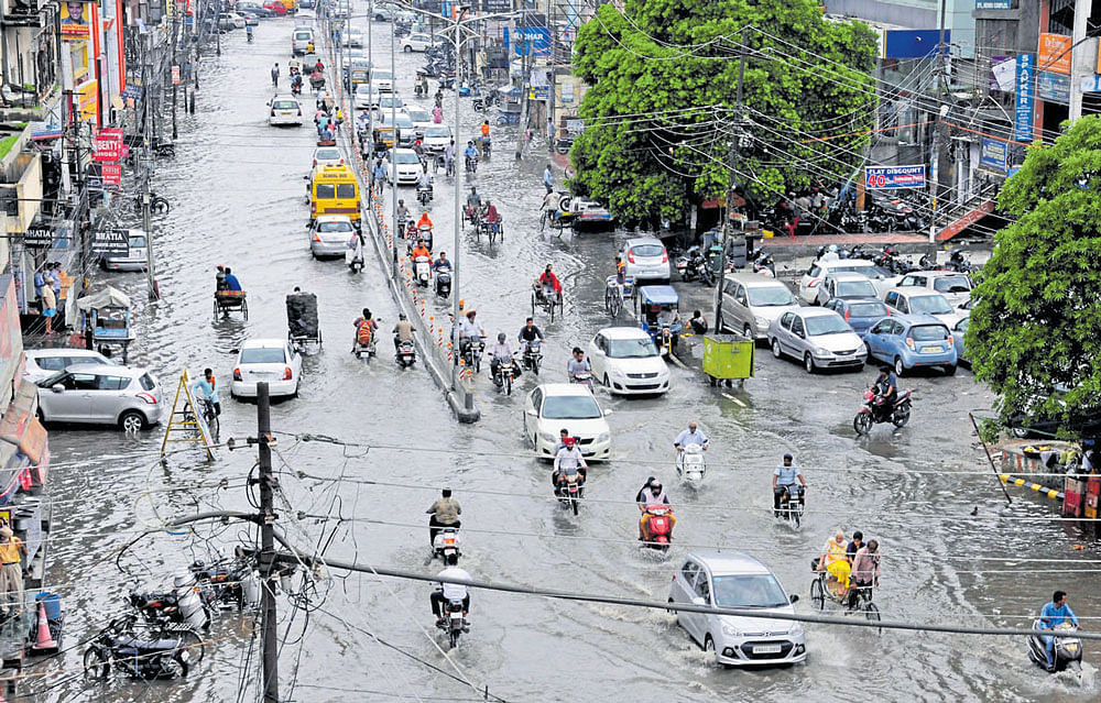 rain woes: Vehicles pass through a waterlogged street after heavy rainfall in Amritsar. PTI/DH photo/Mrityunjay Bose