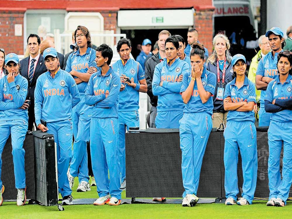 heartbroken: Indian players wear a dejected look after losing a thrilling World Cup final to England at Lord's on Sunday. REUTERS
