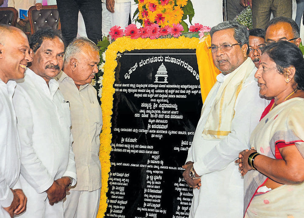 Chief Minister Siddaramaiah unveils the plaque after laying the foundation stone for a flyover in Koramangala on  Monday. DH Photo