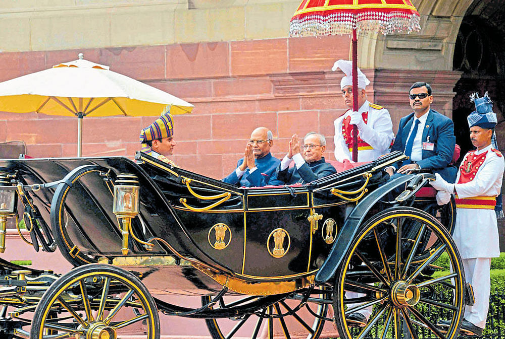 President Ram Nath Kovind with outgoing President Pranab Mukherjee in the traditional buggy in New Delhi on Tuesday. PTI