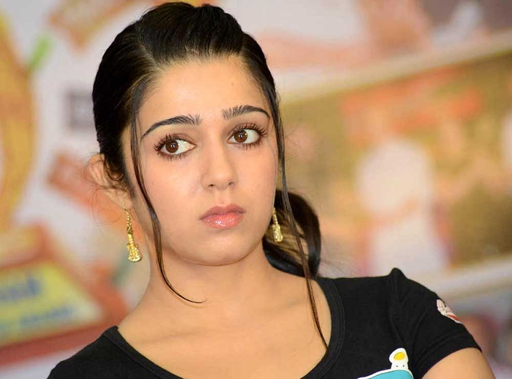 Actor Charmme Kaur being escorted by excise personnel in Hyderabad on Wednesday.