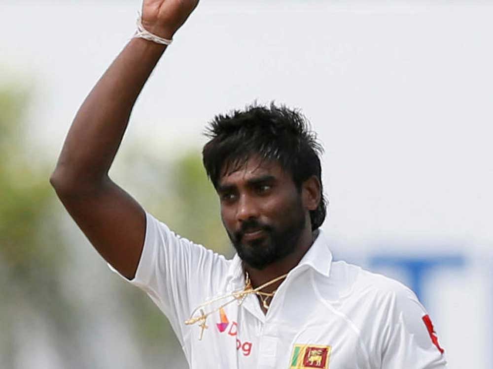 Sri Lanka's Nuwan Pradeep celebrates after taking the wicket of India's Cheteshwar Pujara (not pictured). REUTERS