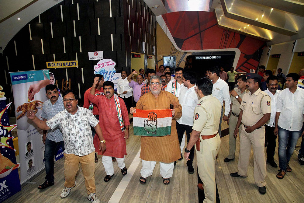 Congress activists protest against 'Indu Sarkar' in a movie theatre in Thane, Mumbai. PTI