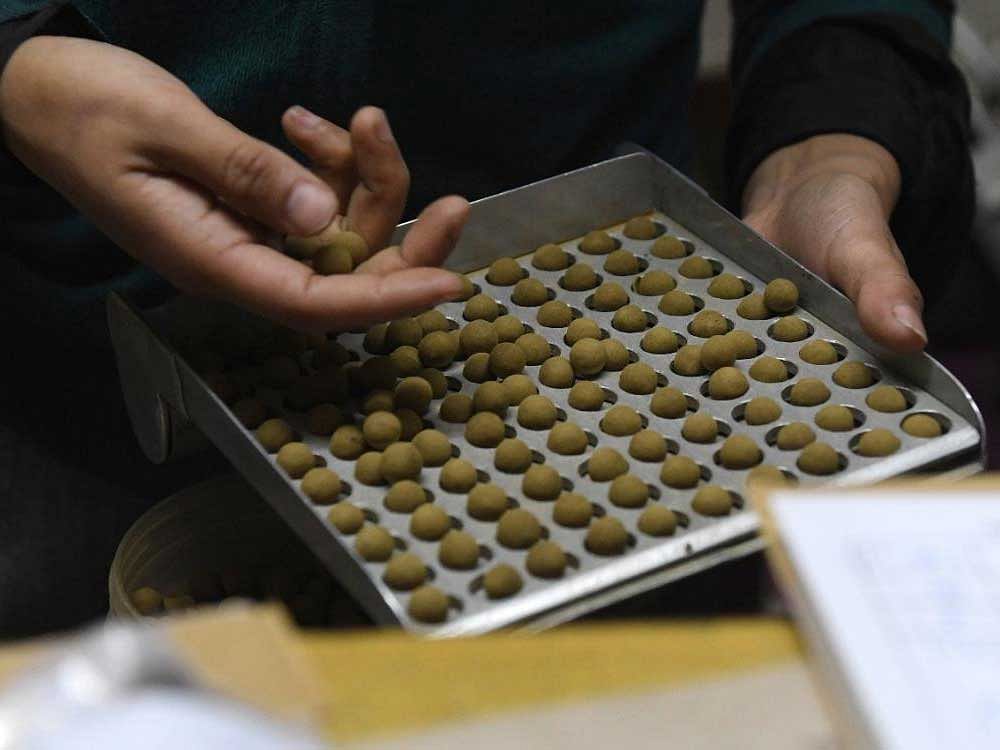 Traditional Tibetan herbal medicine being packed at a clinic in Dharamsala. Western scholars say there are historical links between ayurvedic and Tibetan medical traditions. But India's recent application for Unesco recognition prompted rebuttals from China. afp