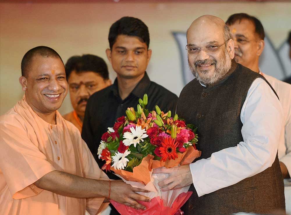BJP National President Amit Shah bieing welcomed by Uttar Pradesh Chief Minister Yogi Aditiyanath at the state office, in Lucknow on Satruday. PTI Photo