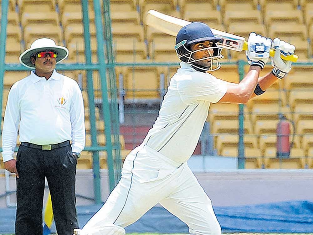 in full flow: KSCA Colts' Suneel Raju slams one to the fence    during his knock of 148 against DY Patil Academy. DH PHOTO