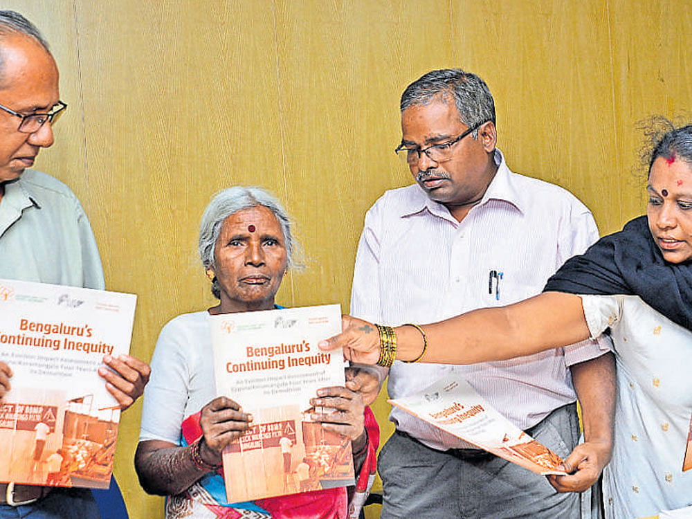 Ejipura residents Violet Mary (2nd from left) and Shanta Mary (4th from left), release the book on 'Bengaluru's  Continuing Inequity: An Eviction Impact Assessment of  Ejipura/Koramangala Four Years After Its Demolition,'  in Bengaluru on Saturday. Prof Y J Rajendra, president of  Peoples' Union for Civil Liberties, Rajendran Prabhakar  from Forum against EWS Land Grab and public health expert Dr Sylviya Karpagam are seen.