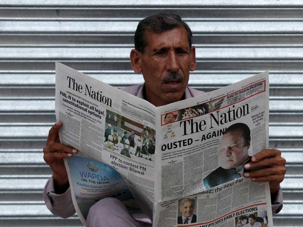 A man reads the news on the disqualification of Pakistan Prime Minister Nawaz Sharif by the Supreme Court, in Peshawar, Pakistan. Coming with less than a year to go in his term, Sharif's ouster will further roil the country's tumultuous political balance. REUTERS