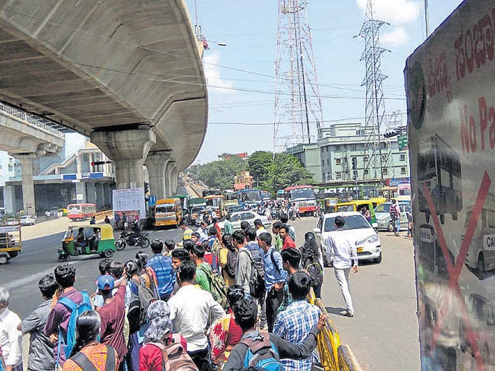 The Jalahalli Cross is almost always crowded with passengers coming onto the middle of the road while waiting for the buses.
